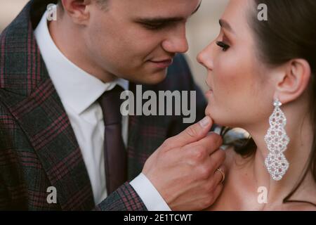 Bräutigam berührt das Kinn der Braut. Nahaufnahme Neuvermähltes Porträt. Hochzeitspaar Stockfoto