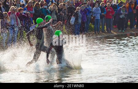 Triathlon-Schwimmer beim Eintritt in die Freiwasserschwimmbühne. Stockfoto