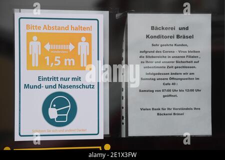 Demmin, Deutschland. Januar 2021. Ein Schild mit der Aufschrift 'Bitte halten Sie Abstand!' Hängt im Eingang einer Bäckerei und Konditorei. Mecklenburg-Vorpommerns Einwohner mussten sich seit 10.01.2021 strengeren Corona-Maßnahmen anpassen. Dazu gehören beispielsweise strengere Kontaktbeschränkungen. Die Mecklenburgische Seenplatte ist die erste Grafschaft des Landes, die ein Corona-Hochrisikogebiet ist. Quelle: Stefan Sauer/dpa-Zentralbild/dpa/Alamy Live News Stockfoto