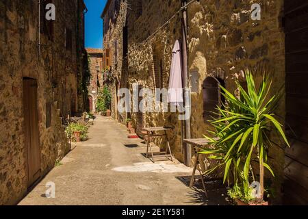 Eine Straße mit historischen Steingebäuden im Dorf Montemerano in der Nähe von Manciano in der Provinz Grosseto, Toskana, Italien Stockfoto