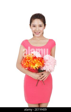 Junge Frau in rosa Kleid mit Blume hohe Qualität Foto Stockfoto