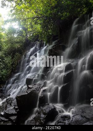 Langzeitbelichtung Panorama der tropischen Luft Terjun Kanto Lampo Wasserfall Kaskade natürliche Felsstufen in Gianyar Bali Indonesien Südosten Asien Stockfoto