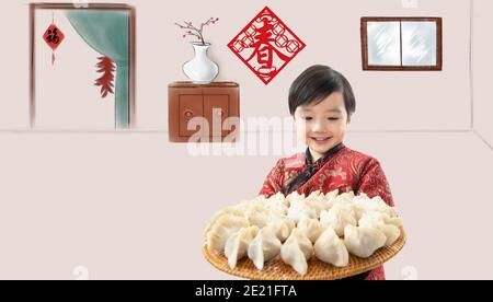 Glücklicher Junge mit Knödeln Neujahr in Stockfoto