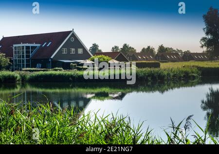 Niederlande, Goes. Holländische Landschaft Seenlandschaft: Schilf am Seeufer. Gruppen von charakteristischen Chalets, eine am Seeufer reflektiert wird Stockfoto