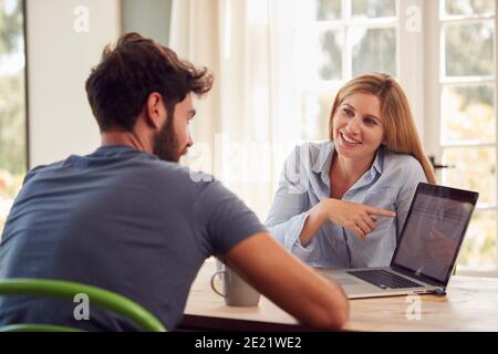 Paar Mit Laptop Sitzen Am Tisch Arbeiten Von Zu Hause Aus Zusammen Stockfoto