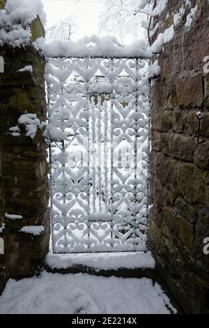 Schmiedeeisernes Tor und schwerer Schneefall fegt durch Yorkshire Kleinbetrieb mit 900 Fuß Stockfoto