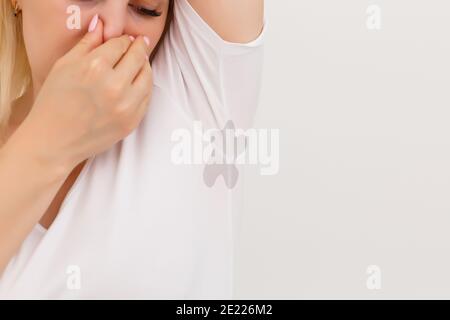 Junge Frau schwitzt zu viel und sie mag es nicht Ihr Geruch unter der Achsel.unangenehmer Geruch unter der Achsel Stockfoto