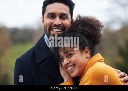 Portrait Of Loving Couple On Outdoor Walk Through Autumn Countryside Gemeinsam Stockfoto