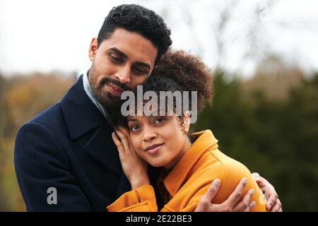 Portrait Of Loving Couple On Outdoor Walk Through Autumn Countryside Gemeinsam Stockfoto