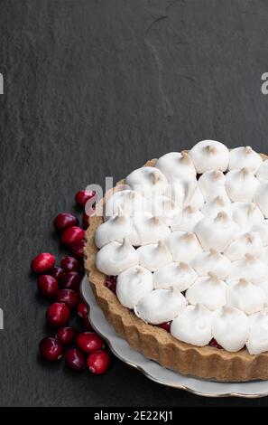 Meringue bedeckt Cranberry Torte Pie auf schwarzem Stein Hintergrund Stockfoto