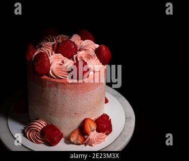 Erdbeeren und Sahnetorte auf Marmorkuchenständer Stockfoto