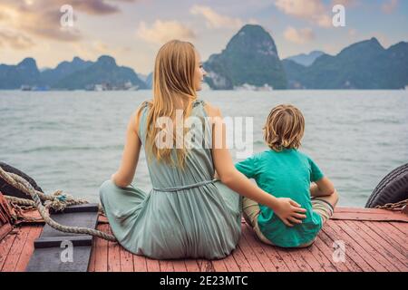 Mom and son travelers is traveling by boat in Halong Bay. Vietnam. Travel to Asia, happiness emotion, summer holiday concept. Traveling with children Stock Photo