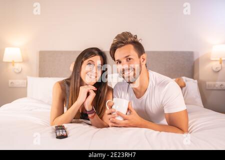 Glückliches liebendes Paar, das sich im Schlafzimmer entspannen kann Stockfoto