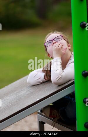 Mädchen auf Spielplatz suchen weg Stockfoto