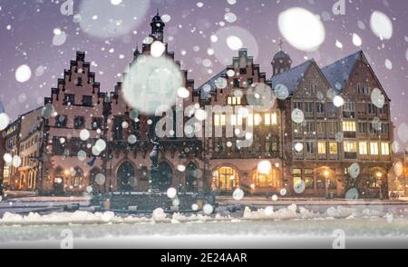 12. Januar 2021, Hessen, Frankfurt/Main: Schneeflocken fallen vor dem historischen Frankfurter Rathaus, dem Römer, auf dem bereits verschneiten Platz. In Hessen ist mit rutschigen Straßen auch in tiefen Höhenlagen zu rechnen. (Foto mit Blitz) Foto: Frank Rumpenhorst/dpa Stockfoto