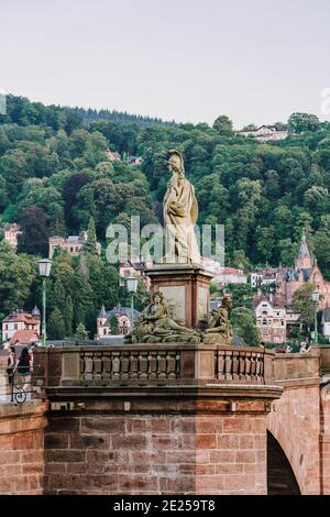 Heidelberg, Deutschland - 1. Aug 2020: Skulptur der römischen Göttin Minerva auf einer alten Brücke nach Sonnenuntergang Stockfoto