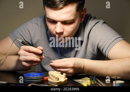 Zahntechniker Modellierung Zahnkronen mit heißem Wachs. Arbeitsplatz eines Zahntechnikers Stockfoto
