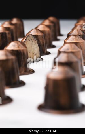 Schokolade Bonbons in Form einer Kaffeekapsel mit Kaffee und Irish Cream Liquor Füllung in einer Reihe. Stockfoto