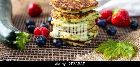 Gesundes Sommerfrühstück mit Zucchini Pfannkuchen, Strategien Früchte Ahornsirup. Gesundes testy Sommer-Frühstück Stockfoto