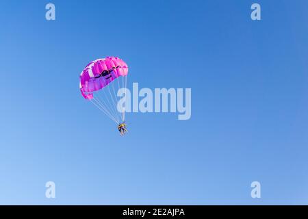 Parasailing wing pulled by boat, summer sunny activities at sea. Recreation outdoors. copyspace Stock Photo