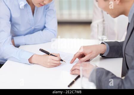 Geschäftsfrau Unterschrift Dokument Geschäftsmann zeigt auf Schreibtisch im Büro hoch Hochwertige Fotos Stockfoto