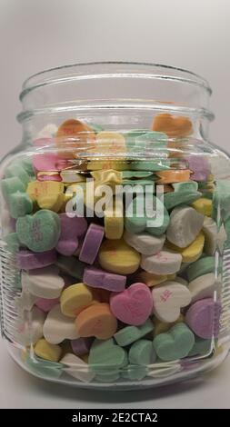 Glas voller Süßigkeiten Gespräch Herzen für Valentinstag Stockfoto