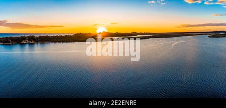 Sonnenuntergang über Küste und Wasser - Luftpanorama Stockfoto