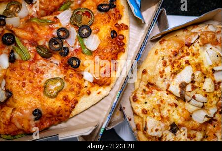 Blick von oben auf zwei verschiedene vegetarische Pizzas zum Mitnehmen Boxen Stockfoto