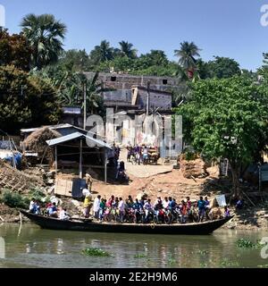 Mayapur-Gebiet, Westbengalen, Indien. Der Fluss Hooghly, Teil des Ganges. Überlastete Fähre mit Passagieren beladen, von denen die meisten auf Rädern oder Motorrädern sind Stockfoto