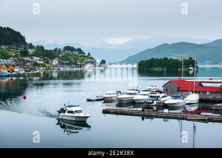 Wolkiger Sommerblick auf Hardangerfjord und Norheimsund Dorf, Norwegen, Europa. Landschaftsfotografie Stockfoto