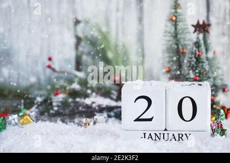 Weiße Holz Kalenderblöcke mit dem Datum 20. Januar und Weihnachtsdekorationen mit Schnee. Selektiver Fokus mit unscharfem Hintergrund. Stockfoto