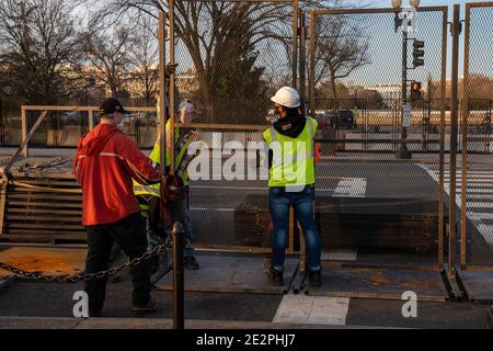 Washington, Usa. Januar 2021. Die Arbeiter legen vor der Amtseinführung von Präsident Biden in Washington, DC, am Donnerstag, dem 14. Januar 2021, einen etwa 8 Meter hohen Umzäunungszaun um das Weiße Haus. Zusätzliche Sicherheit ist auf Hochalarm, nachdem Pro-Trump MAGA-Mobs den Sicherheitsbereich durchbrochen und das US-Kapitol am 6. Januar eingedrungen haben. Foto von Ken Cedeno/UPI . Kredit: UPI/Alamy Live Nachrichten Stockfoto