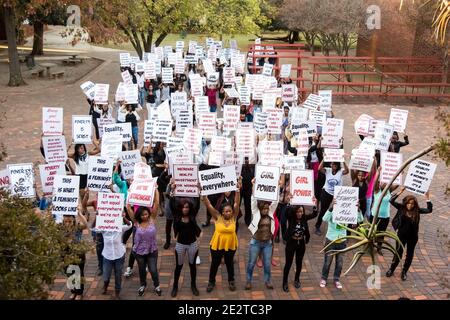 Johannesburg, Südafrika - 30. April 2015: Inszenierter Frauenprotest-marsch in einer Vorstadtstraße, der in Musikvideos für Wohltätigkeitszwecke verwendet werden soll Stockfoto