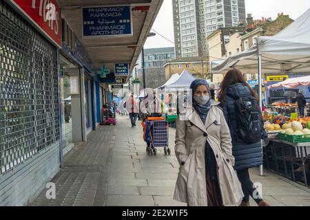 London - Januar 2020: Ethnisch unterschiedliche Menschen tragen Covid 19 Gesichtsmasken auf der Church Street bei der Egdware Road in Westminster. Stockfoto