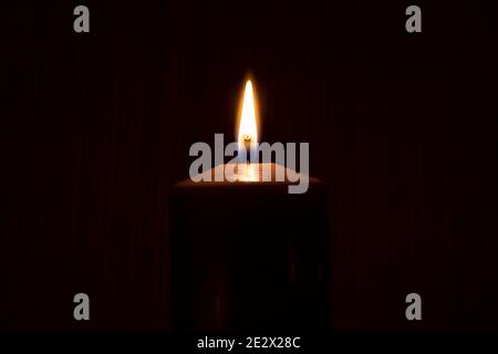 Nahaufnahme der beleuchtete Kerze vor schwarzem Hintergrund Stockfoto