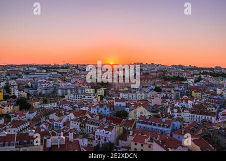 Sonnenuntergang von Miradouro da Senhora do Monte, Lissabon, Portugal. Ein atemberaubender Blick über die gesamte Stadt und Skyline, mit einem klaren, wolkenlosen Himmel. Stockfoto