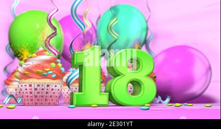 Geburtstagskuchen mit Funkenkerze mit der Nummer 18 groß In grün mit Cupcakes mit roter Creme mit Schokolade verziert Chips und Luftballons auf Th Stockfoto