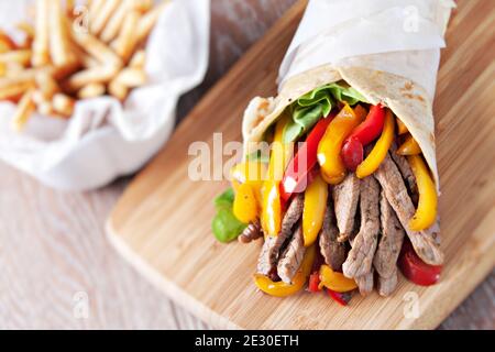 Mexikanische Fajita, Wrap aus Tortilla, Rindfleisch, frisches Gemüse. Stockfoto