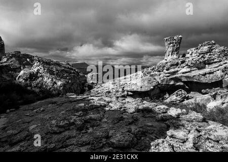 Die zerklüftete und verwitterte Landschaft rund um die Stadsaal-Höhlen in den Cederberg-Bergen Südafrikas in Monochrom. Sonnenlicht, das den beleuchtet Stockfoto