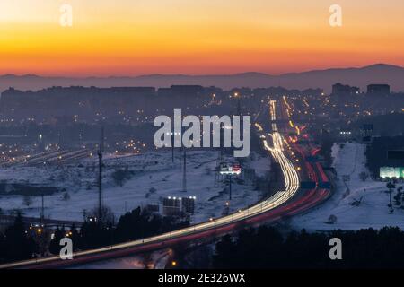 Madrid, Spanien. Januar 2021. Verkehr auf der AUTOBAHN A-3 von Madrid. Die Verschmutzung hat sich in den letzten Tagen nach dem Schneesturm "Filomena" aufgrund der Antizyklonsituation mit sonnigem Wetter, niedrigen Temperaturen, Windlosigkeit und dem Phänomen der thermischen Umkehrung erhöht. Quelle: Marcos del Mazo/Alamy Live News Stockfoto