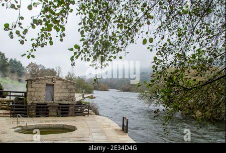 Alte Wassermühle Muino da Veiga und Thermalquellen am Minho Flussbett in Ourense, Spanien Stockfoto