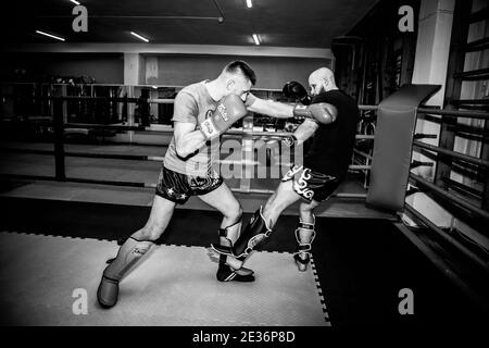 Russia. Vyborg. 12.12.2020 Two men sparring in the ring according to thai boxing rules. High quality photo Stock Photo