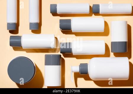 Kosmetische Produkte für die Hautpflege auf beigem Hintergrund. Cremes, Seren, Lotionen mit leerer Verpackung. Beauty- und Spa-Konzept. Stockfoto