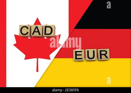 Kanada und Deutschland Währungen Codes auf nationalen Flaggen Hintergrund. Internationales Geldtransferkonzept Stockfoto