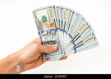 Hand mit Geld isoliert auf weißem Hintergrund. US-Dollar-Scheine Stockfoto
