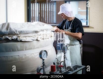 Herstellung von japanischem Sake: Brauerei Akashi Sake Brewery, dampfender Reis für Sake, Präfektur Hyogo, Japan. Stockfoto