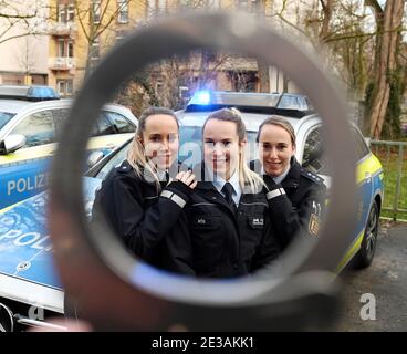 Karlsruhe, Deutschland. Januar 2021. Die identischen Drillinge, (l-r) Vanessa, Lara und Samira Böß, fotografierten durch einen Handverschluss am Karlsruher Polizeipräsidium. Alle drei arbeiten für die Polizei. (To dpa: 'Drillinge erfüllen Jugendlichen Traum in der Polizei') Quelle: Uli Deck/dpa/Alamy Live News Stockfoto