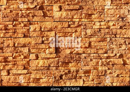 Sonnenlicht Hard beleuchtet einen orangen Steinhintergrund von alten Fliesen. Stockfoto