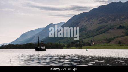 Ein Boot liegt in Loch Lochy bei Laggan Locks im Great Glen, unter den Bergen der schottischen Highlands. Stockfoto