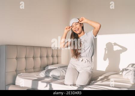 Glückliche Frau, die früh morgens aus bequemem Schaumlatex aufwacht Matratze Bett gesunden Schlaf in Luxus-Schlafzimmer genießen entspannen Wochenende Springen im Bett Stockfoto